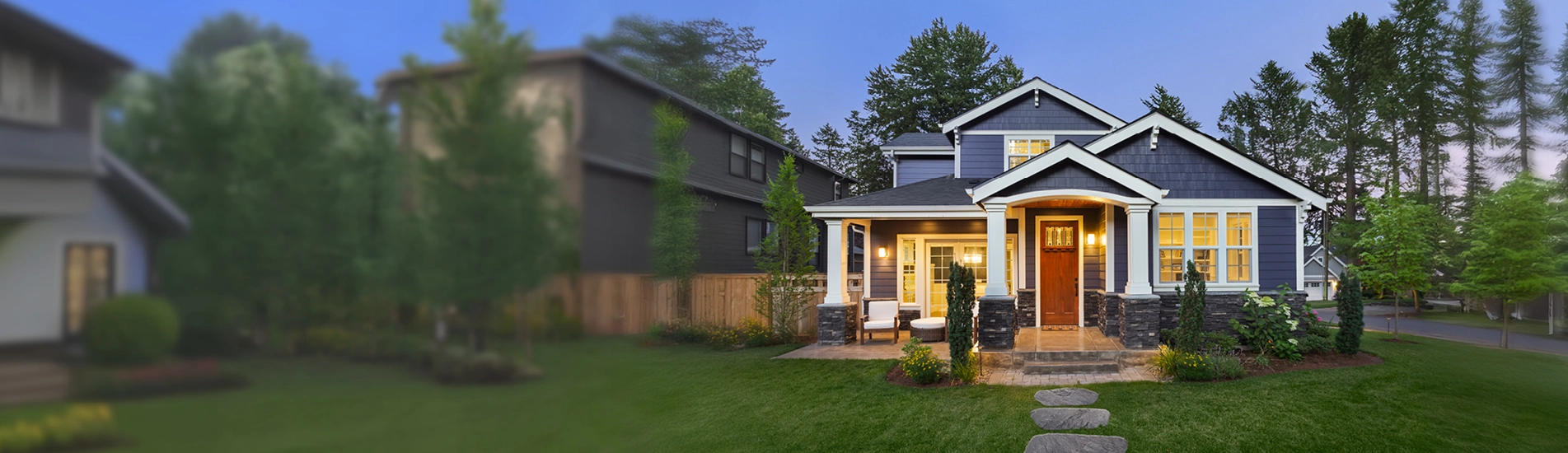 A house in the suburbs with lights on at duskdad and child walking through an evergreen forest